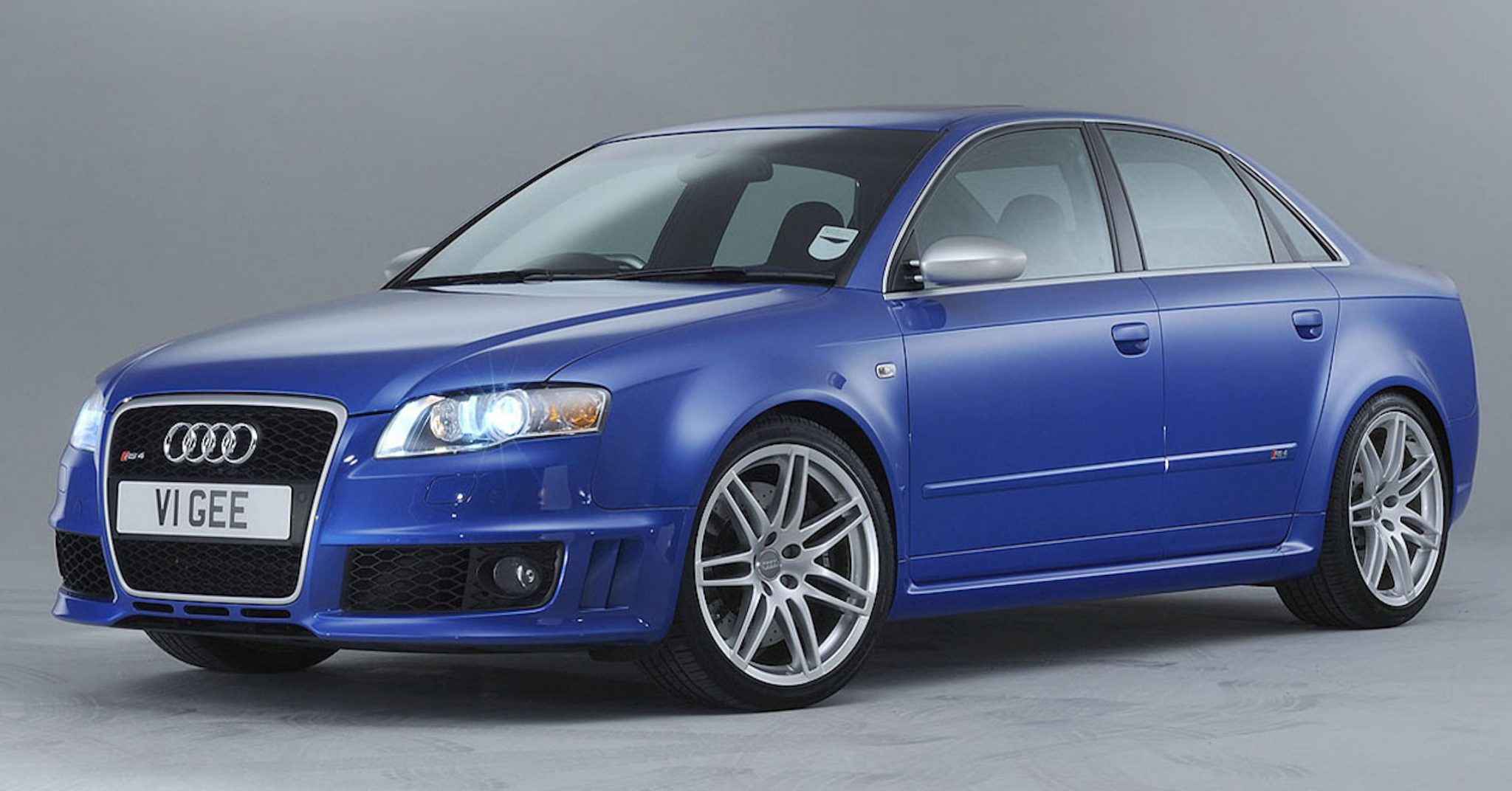 A side view of a blue 2006 Audi RS4 B7 Sedan in a photography studio