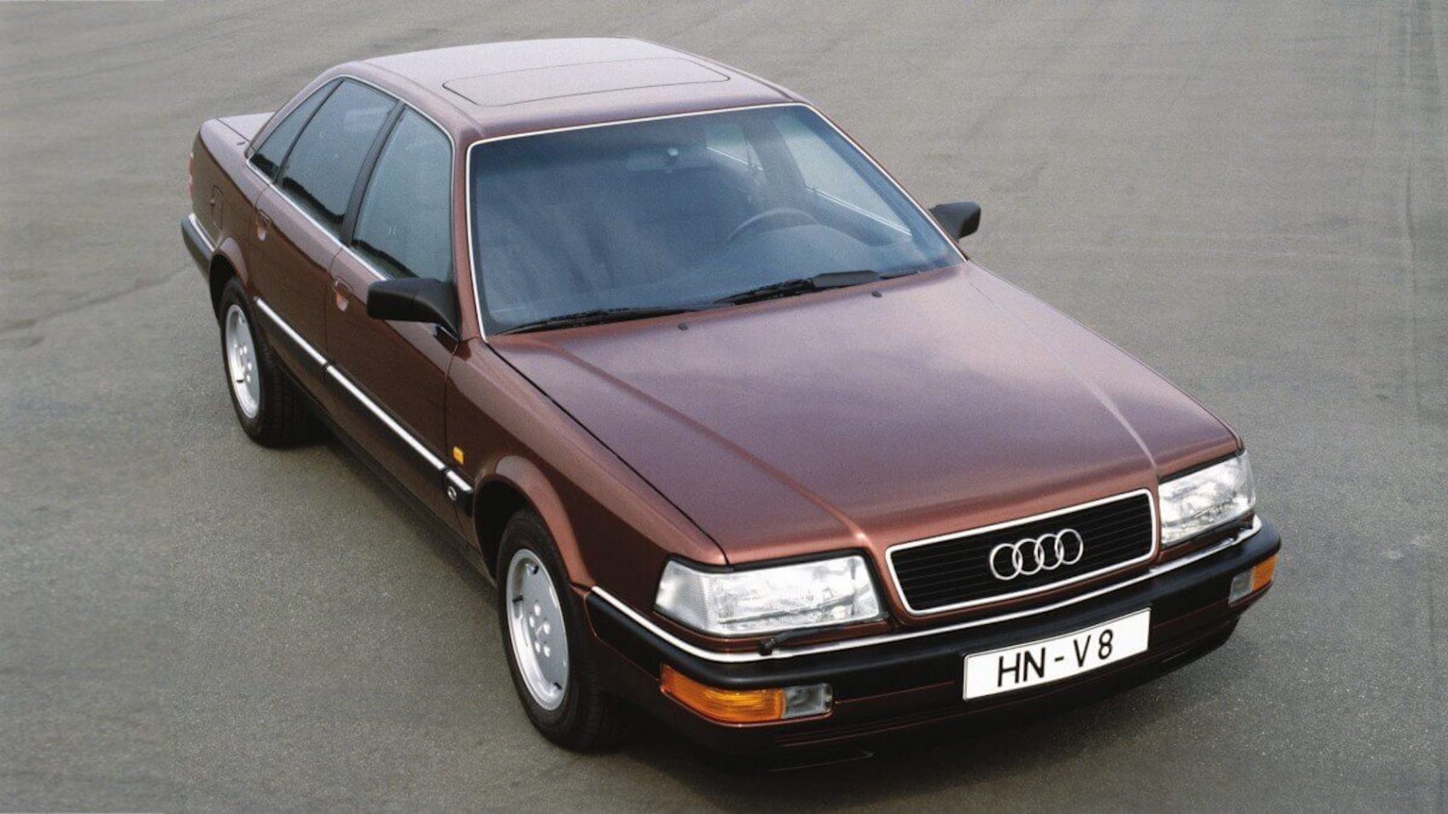 A side view of a brown 1988 Audi V8 Sedan in a parking lot