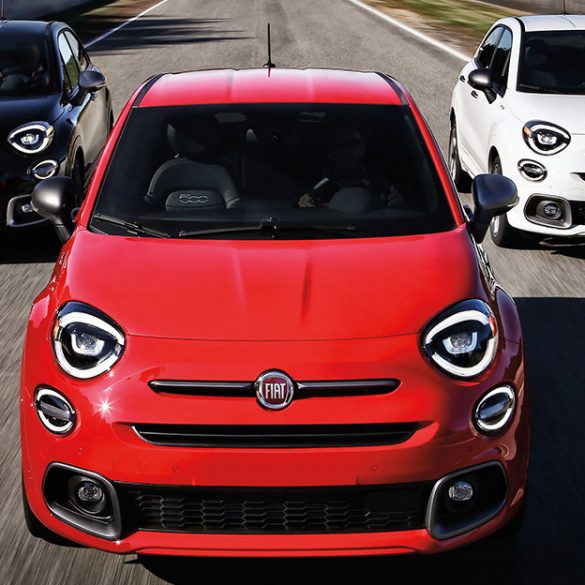Three Fiat 500x Crossover cars in red and white and blue racing down road