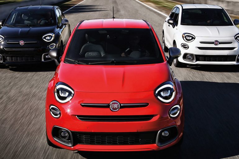 Three Fiat 500x Crossover cars in red and white and blue racing down road