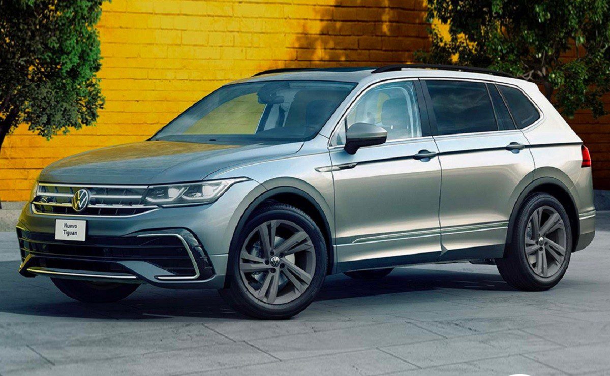 Grey 2022 Volkswagen Tiguan parked on street outside yellow brick wall