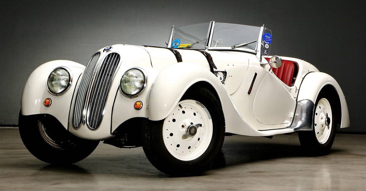 A 1936 White BMW 328 in a showroom.