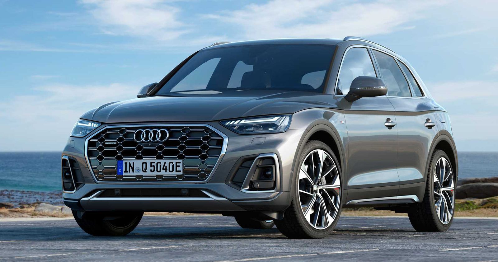 2022 grey Audi Q5 TFSI e Plug-In Hybrid crossover with water background