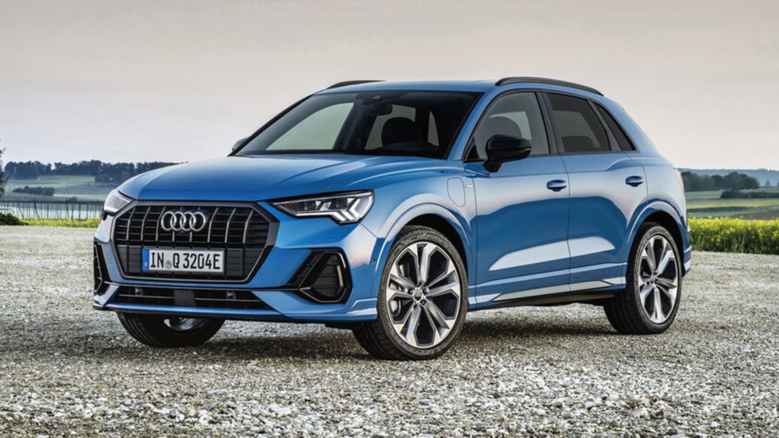  2022 blue Audi Q3 SUV with country background