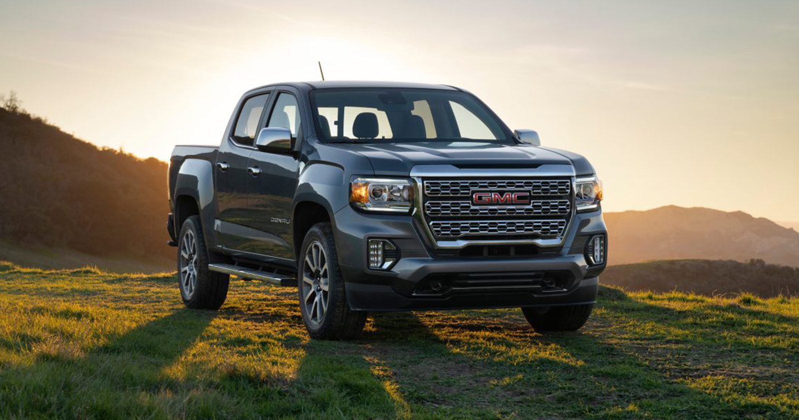 2022 grey GMC Canyon off-road with sunset background