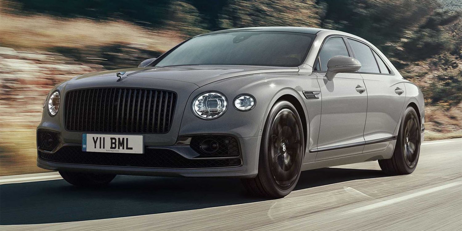 Grey luxury sedan speeding down road