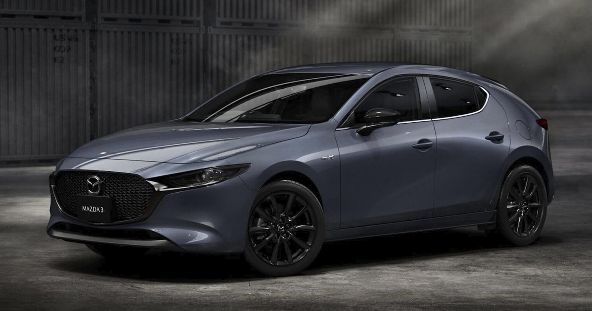2022 gray Mazda 3 hatchback on industrial setting