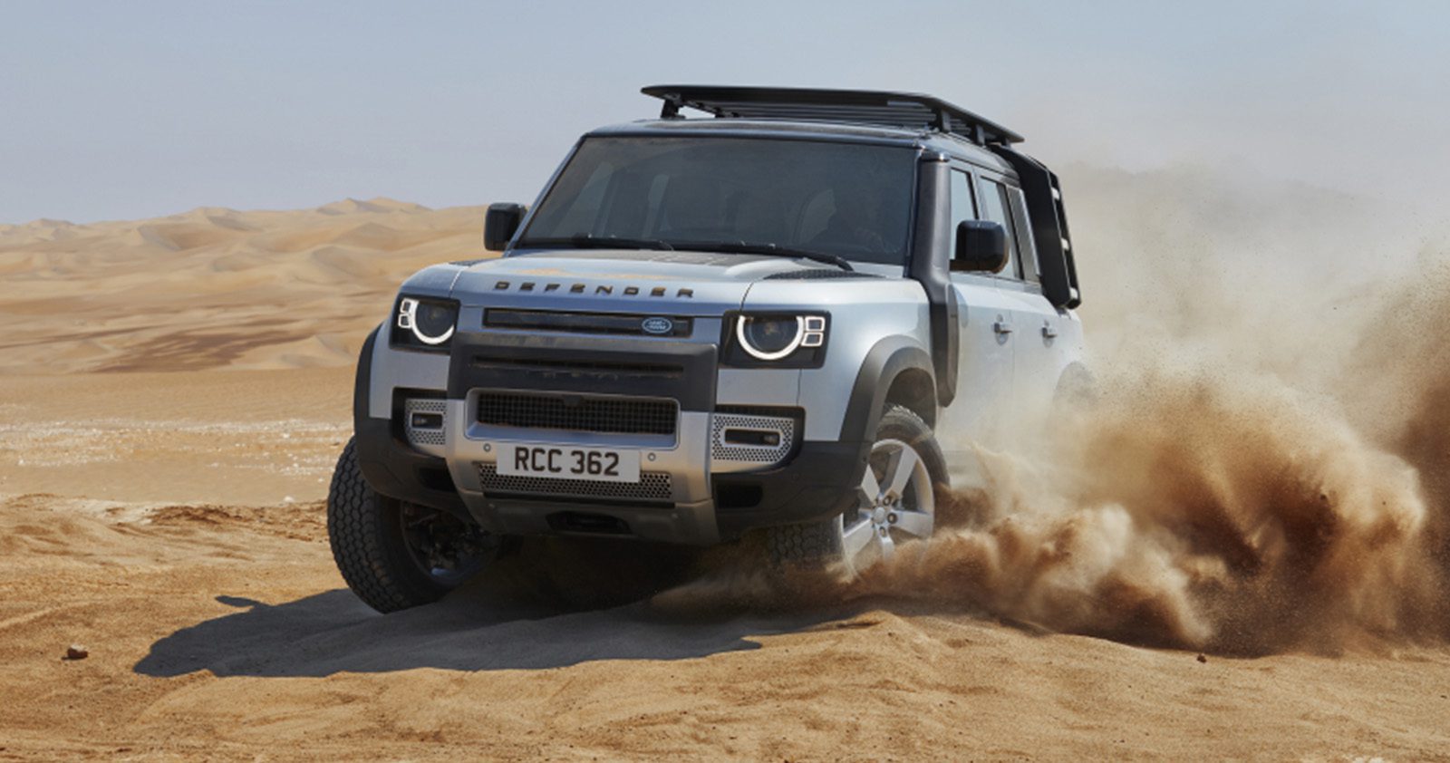 Silver new-generation Land Rover Defender in dunes