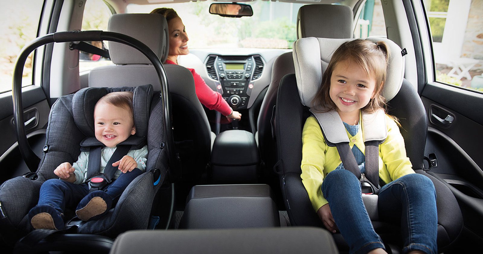 Baby and little girl in child seats