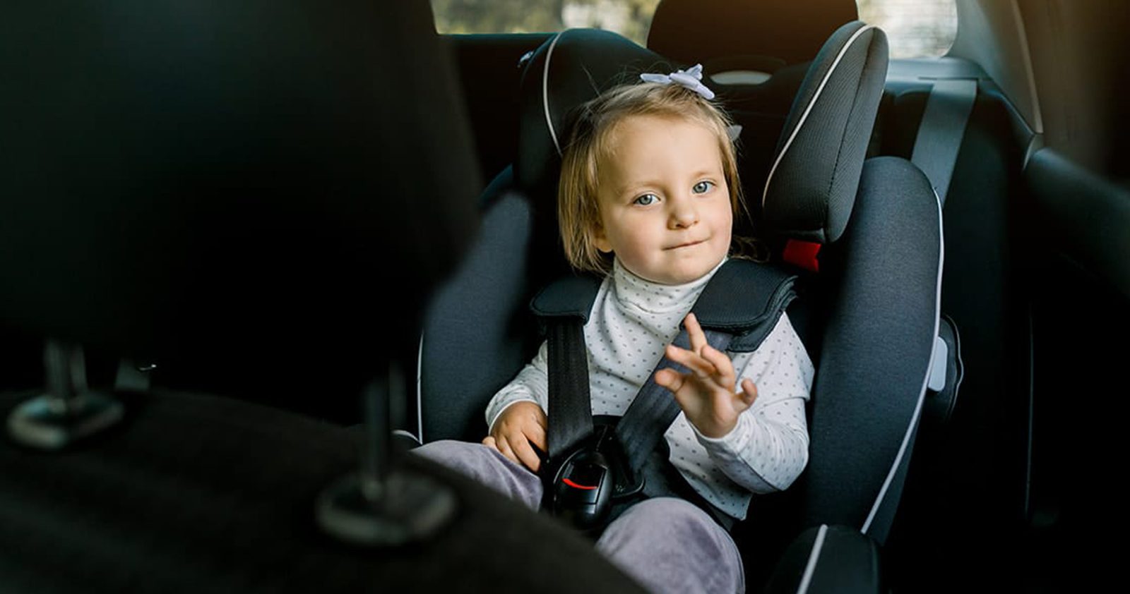 Toddler on a 5 point harness child seat