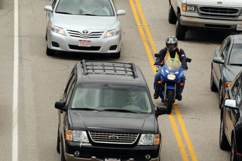 Motorcyclist filtering lanes in American road