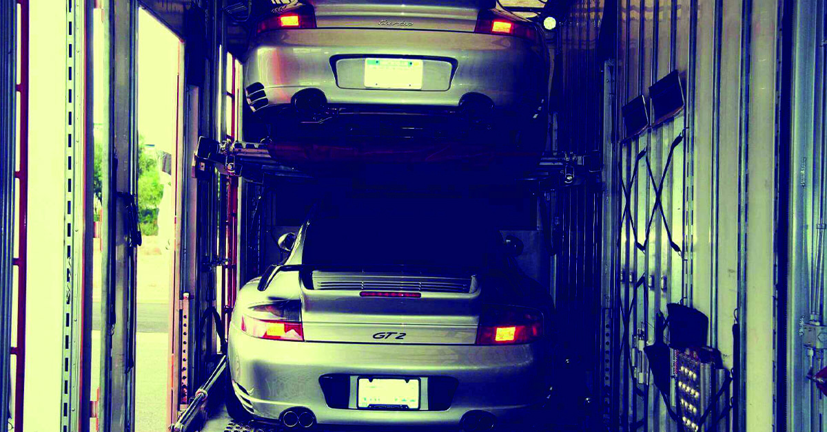 Two Porsche Carrera GT2 inside enclosed auto transport