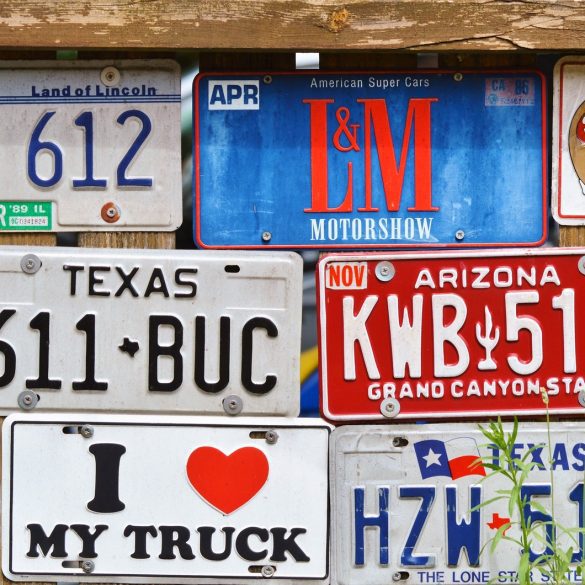 Various license plates on a wall