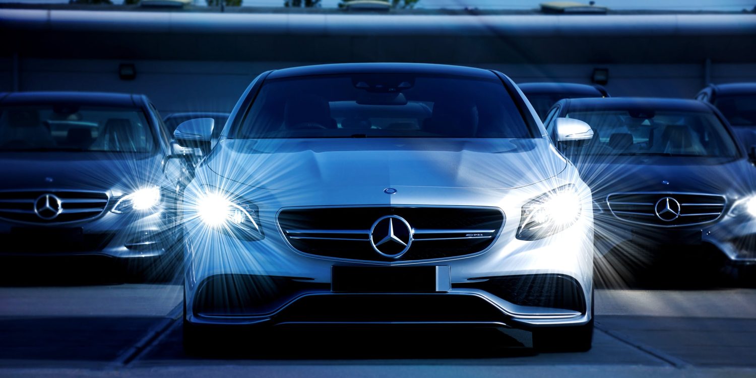 Front view of silver car with bright custom headlights flashing