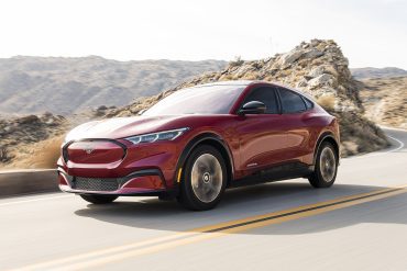 Three-quarter front view of a 2023 Ford red Mustang Mach e