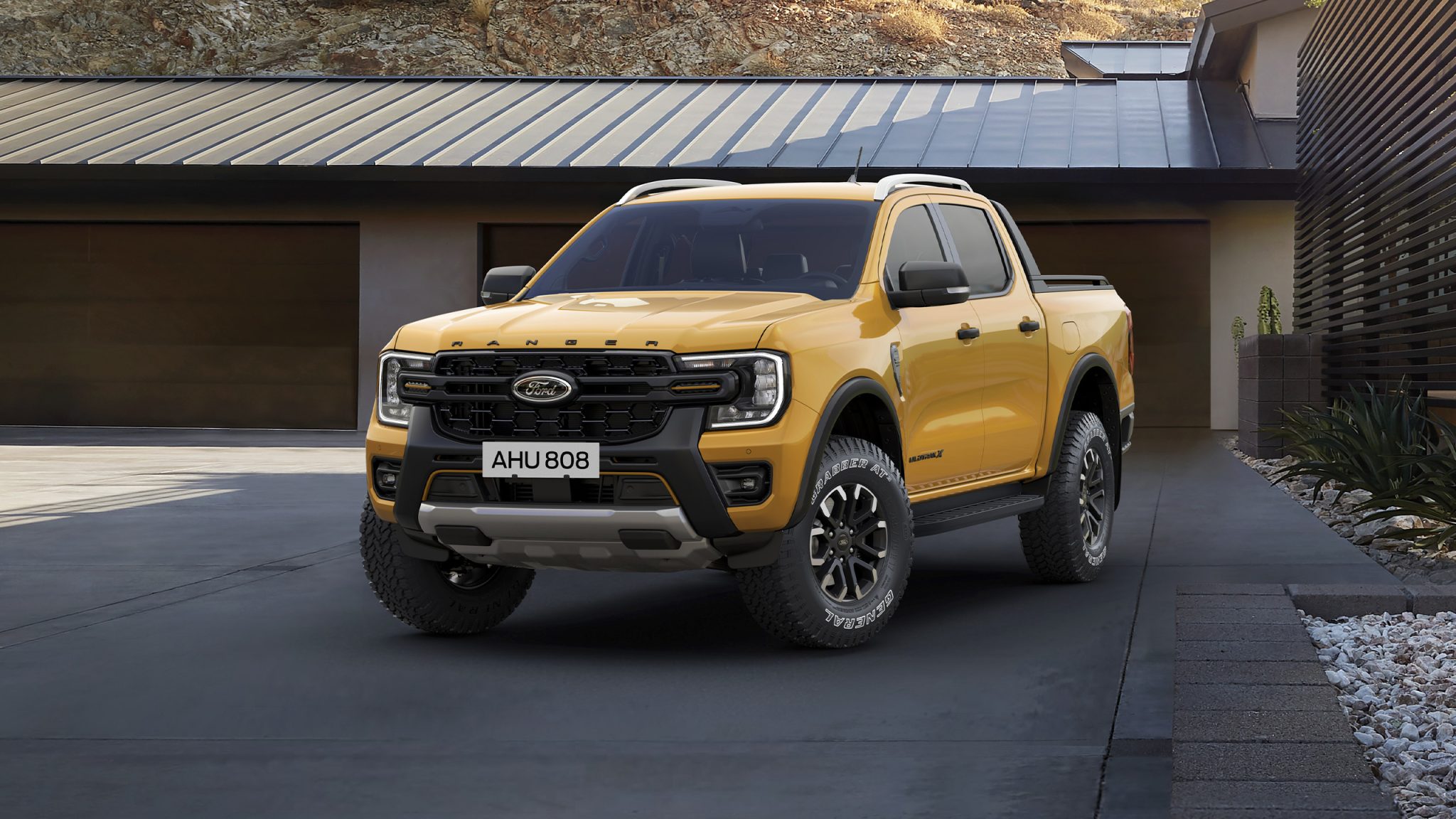 Three-quarter front view of a 2023 yellow Ford Ranger