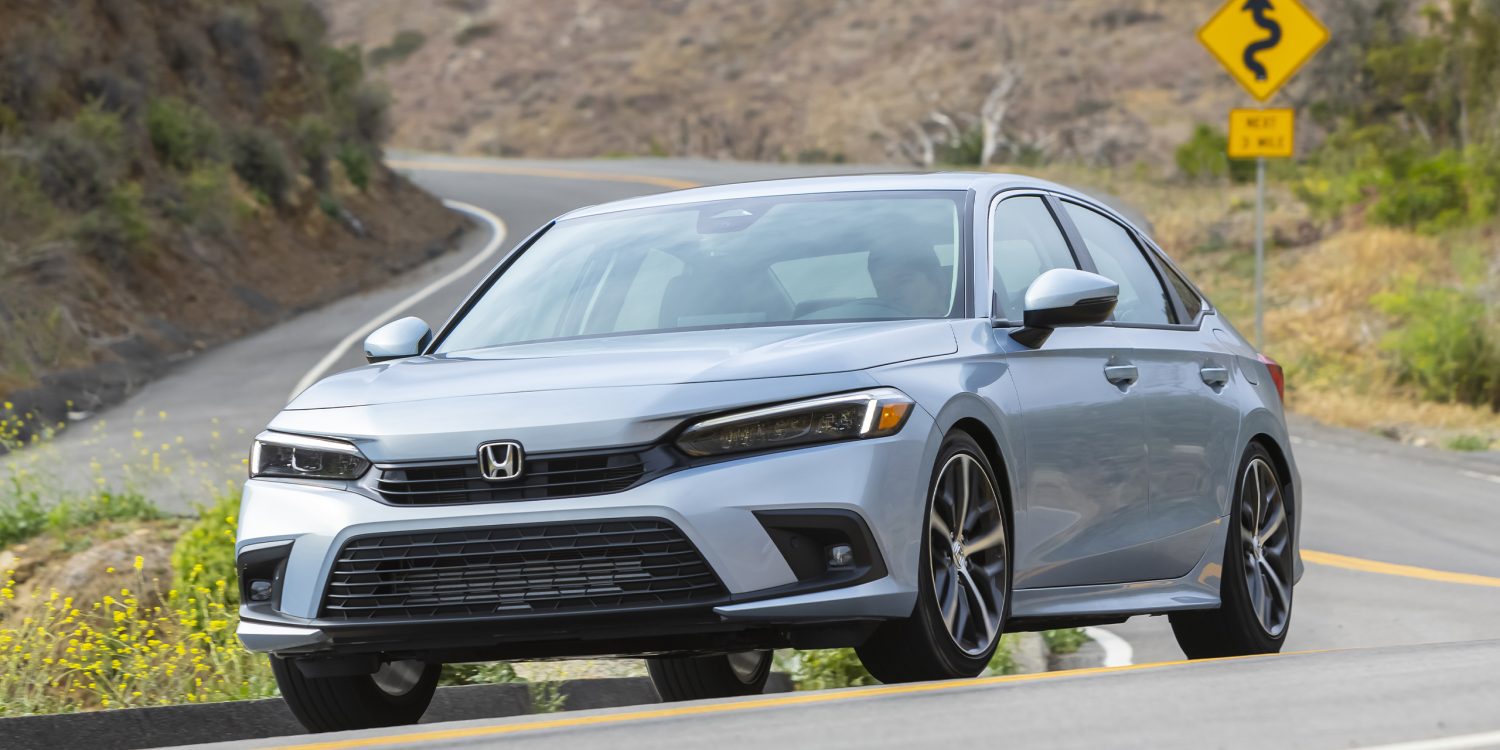 Three-quarter front view of a 2023 blue Civic Sedan