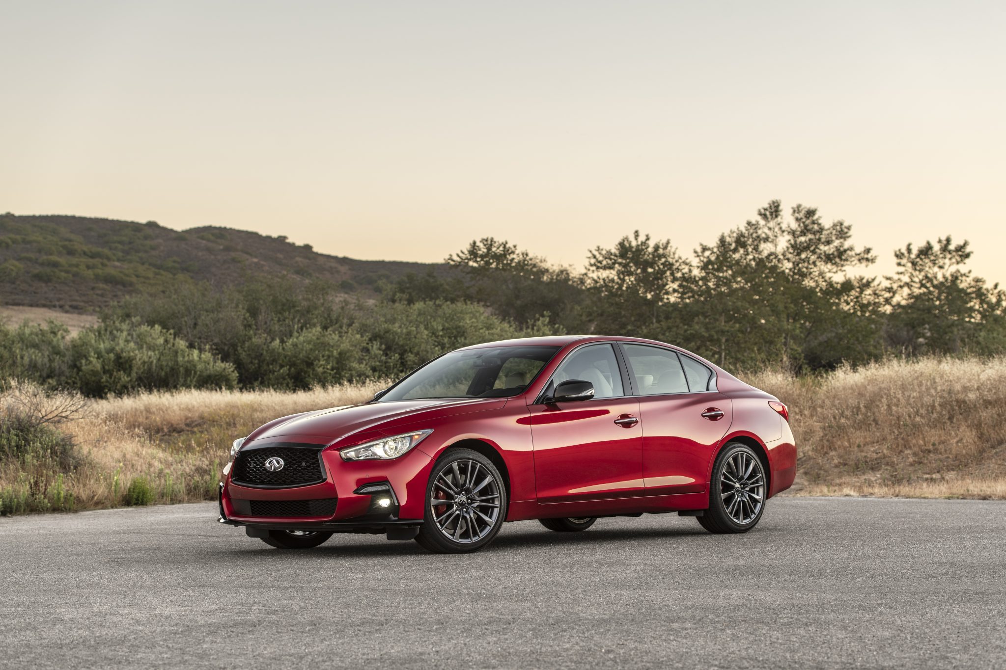 Side view of a 2023 red Infiniti Q50