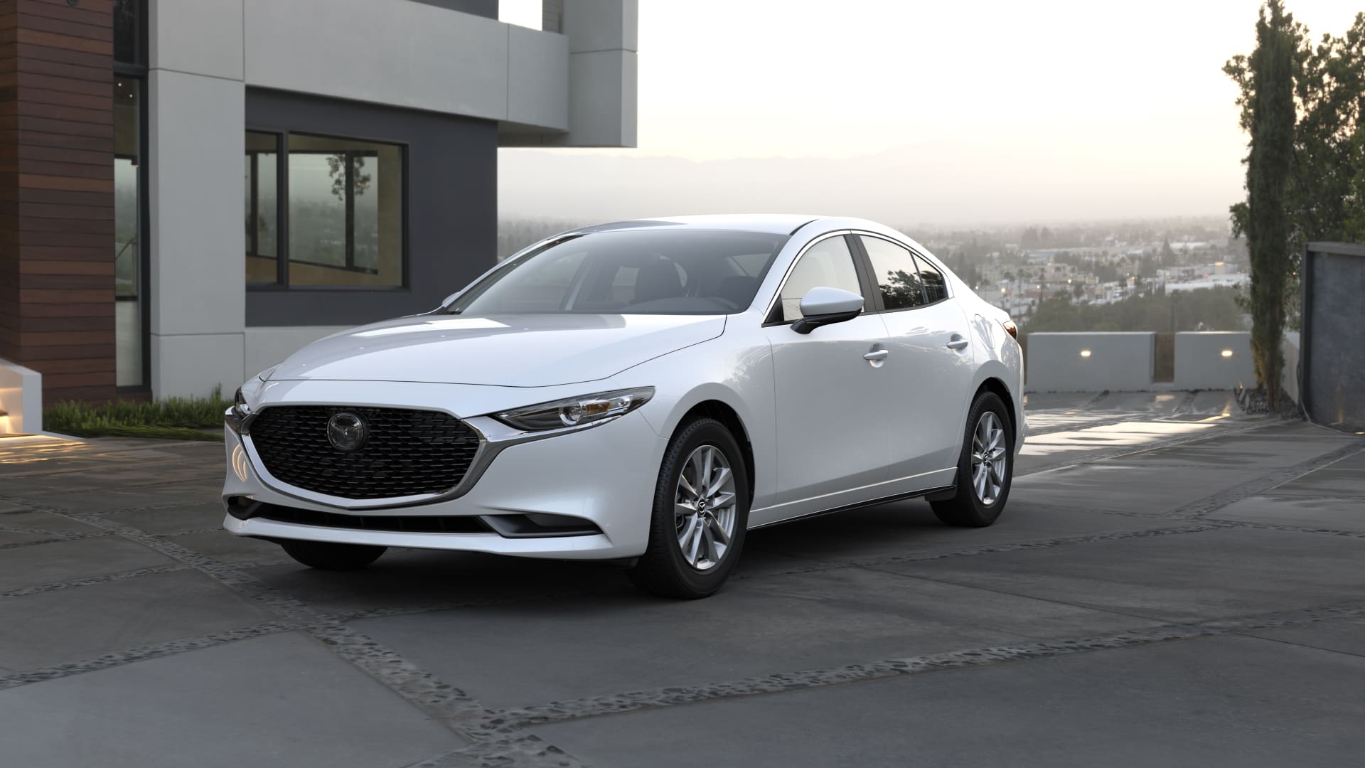 Three-quarter front view of a 2023 white Mazda 3