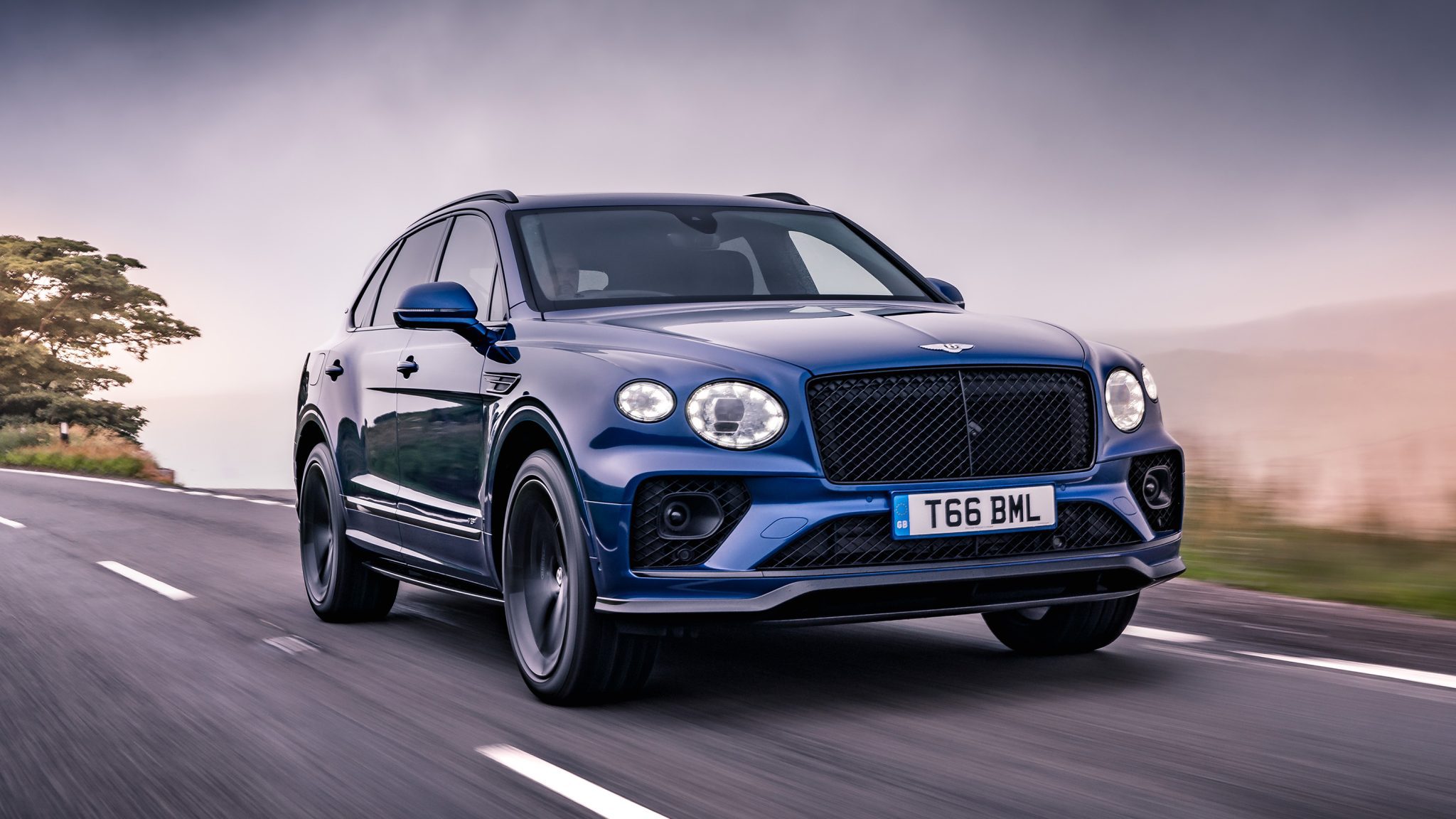 Front angled view of a blue Bentley Bentayga