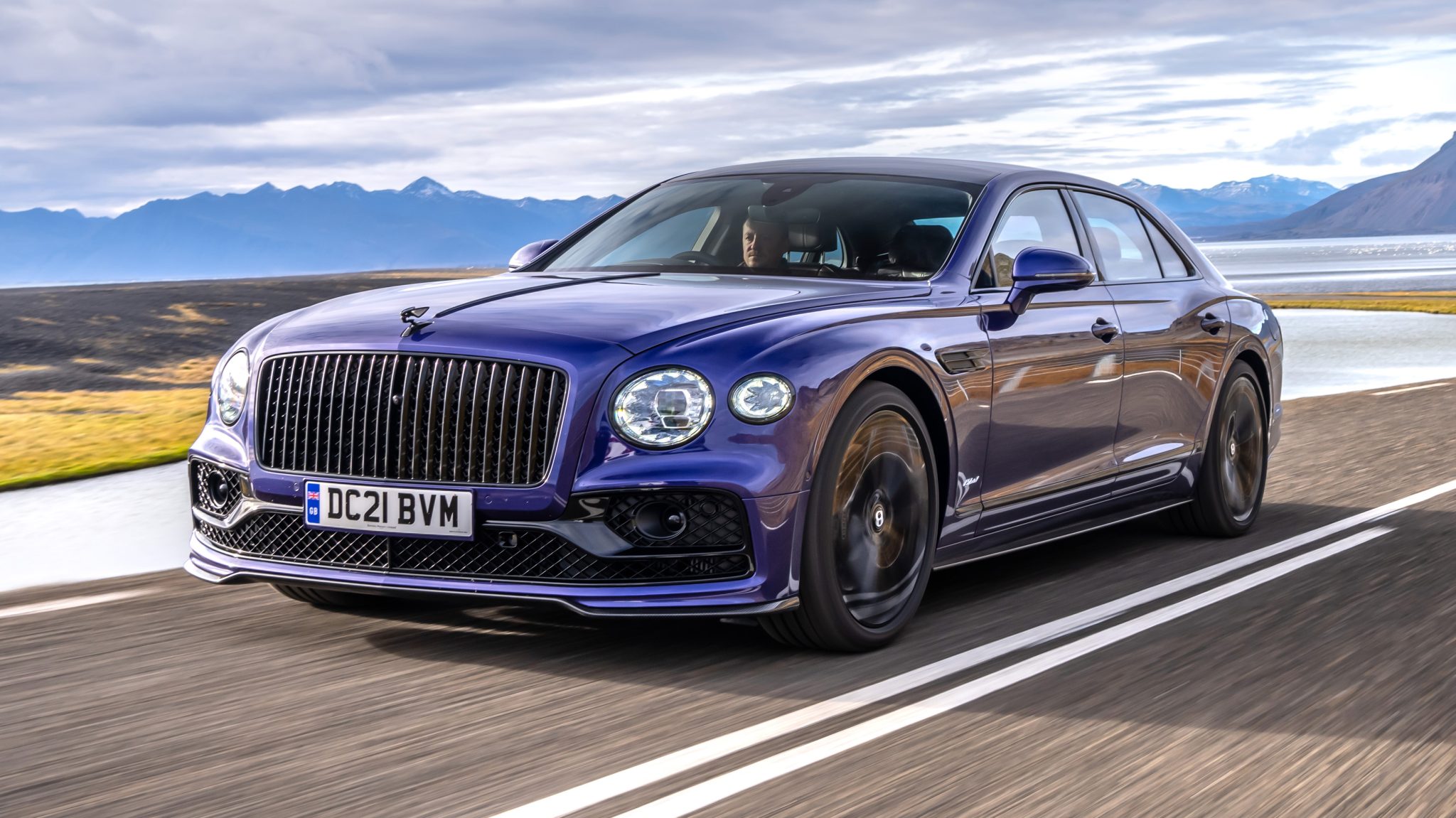 front angled view of a blue 2023 Bentley Flying Spur Plug-in Hybrid