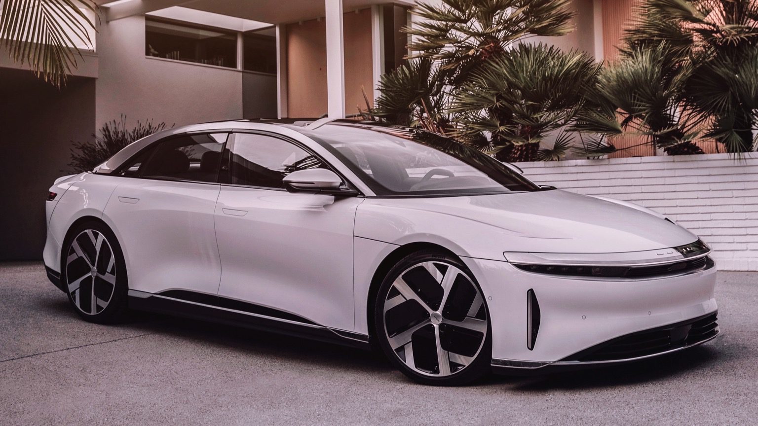 front angled view of a white Lucid Air Touring EV sedan