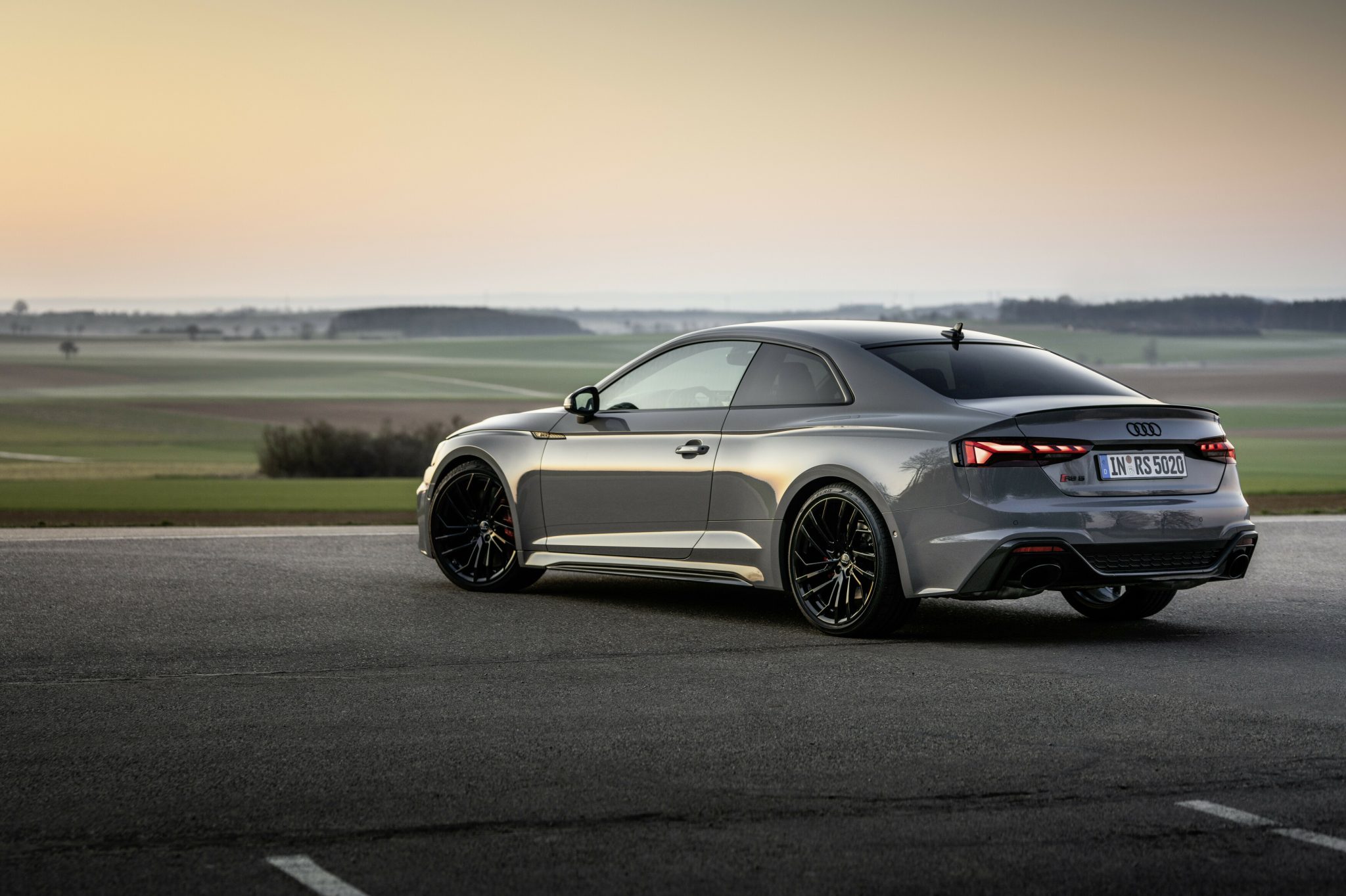 Three-quarter rear view of a 2023 grey Audi RS5 Coupe