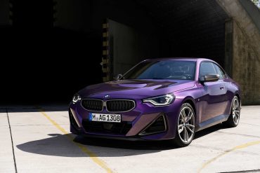Three-quarter front view of a 2023 purple BMW 2 Series coupe