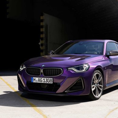 Three-quarter front view of a 2023 purple BMW 2 Series coupe