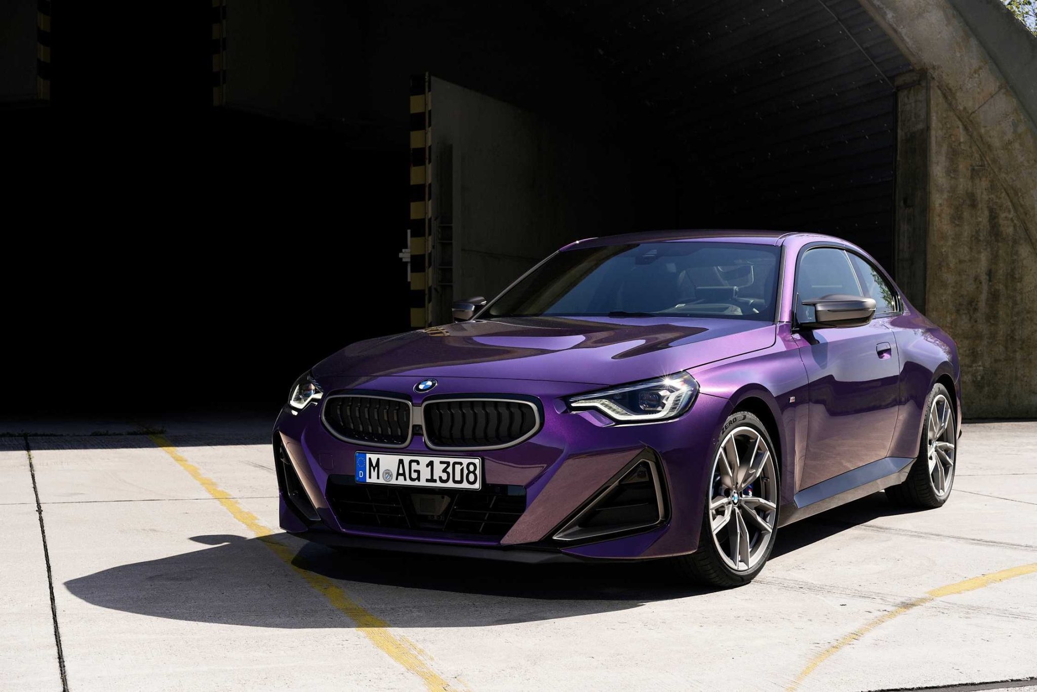 Three-quarter front view of a 2023 purple BMW 2 Series coupe