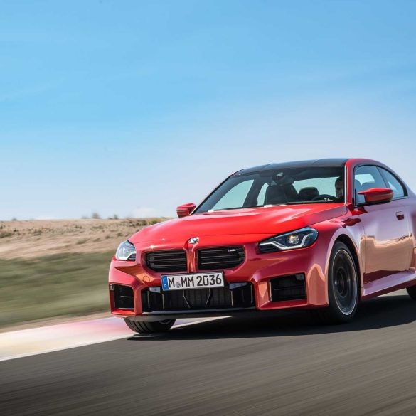 Three-quarter front view of a 2023 red BMW M2