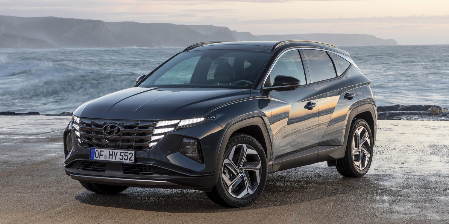 Three-quarter front view of a 2023 blue Hyundai Tucson Hybrid