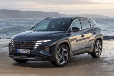 Three-quarter front view of a 2023 blue Hyundai Tucson Hybrid