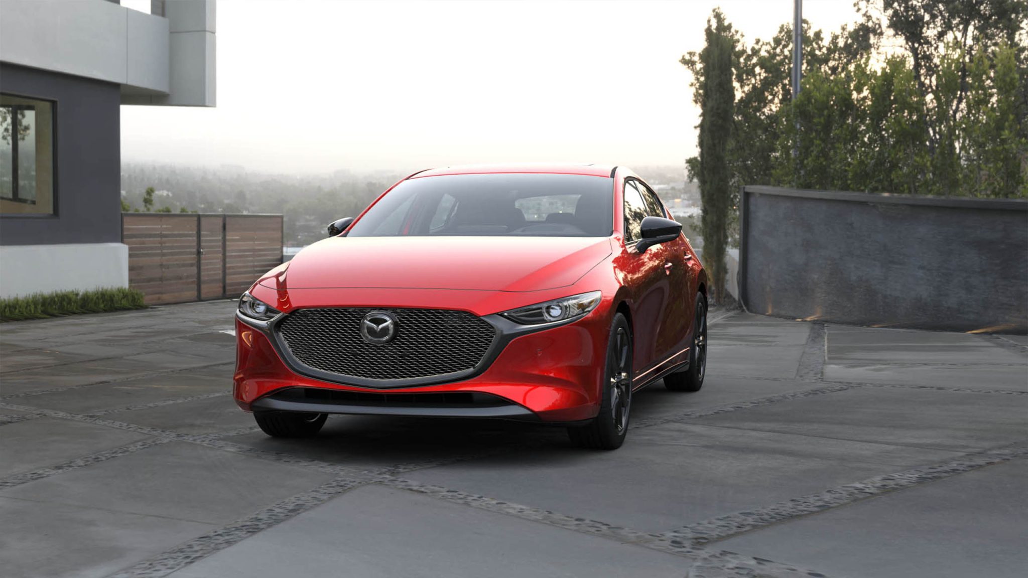 Front view of a 2023 red Mazda 3 hatchback