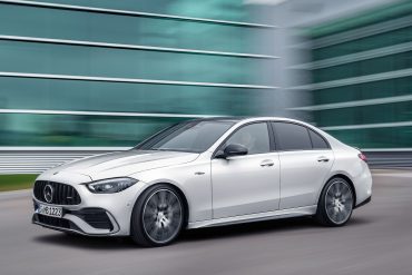Three-quarter side view of a 2023 white Meredes AMG C43 4Matic