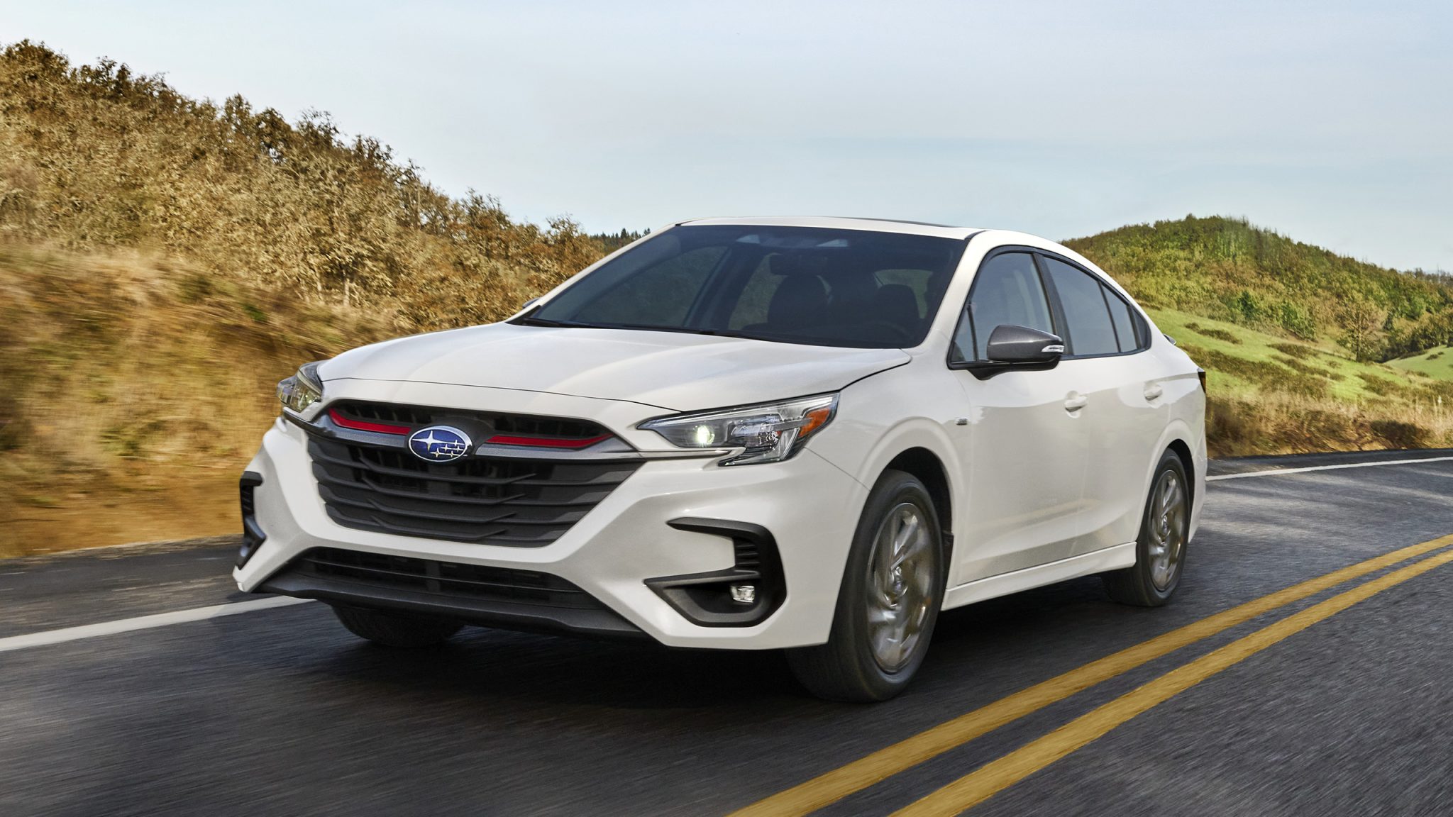 Three-quarter front view of a white Subaru Legacy