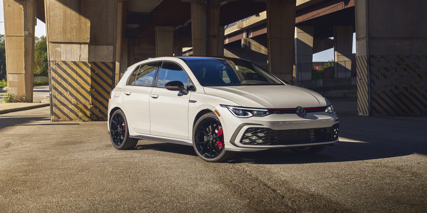 Three-quarter front view of a 2023 white Volkswagen Golf GTI