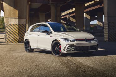 Three-quarter front view of a 2023 white Volkswagen Golf GTI