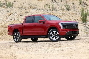 front angled view of a red Ford F-150 Lightning