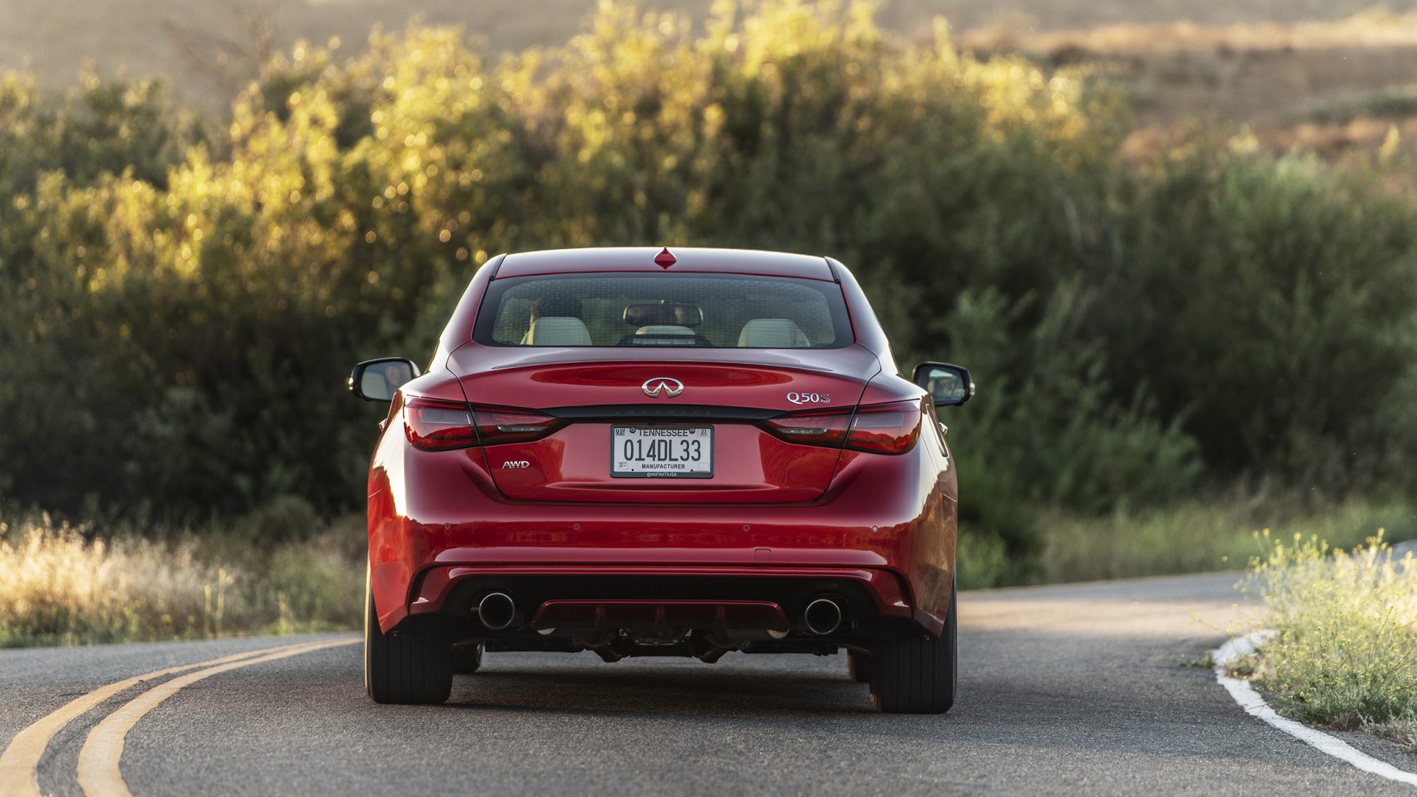 Rear view of a 2023 red Infiniti Q50