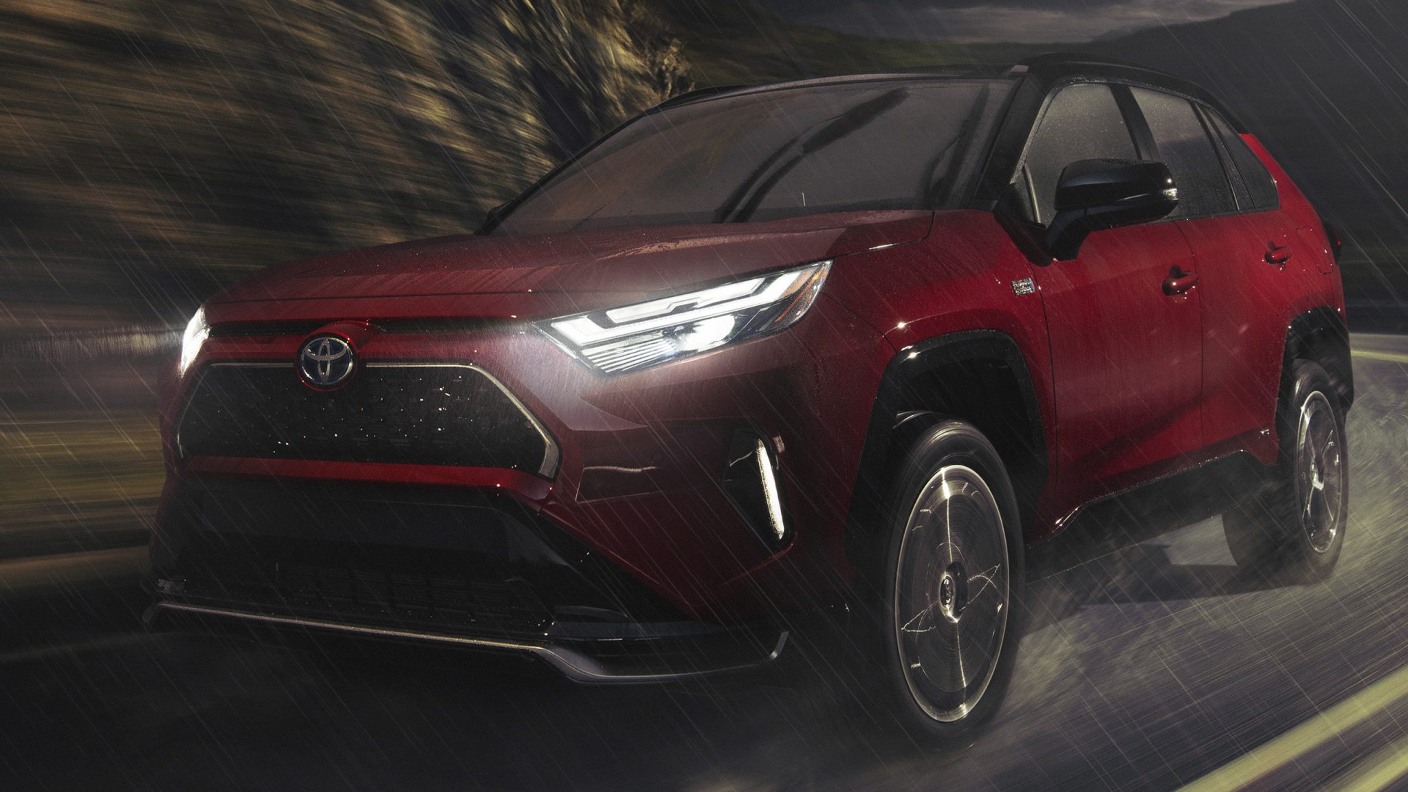Three-quarter front view of a 2023 red Toyota RAV4 Prime