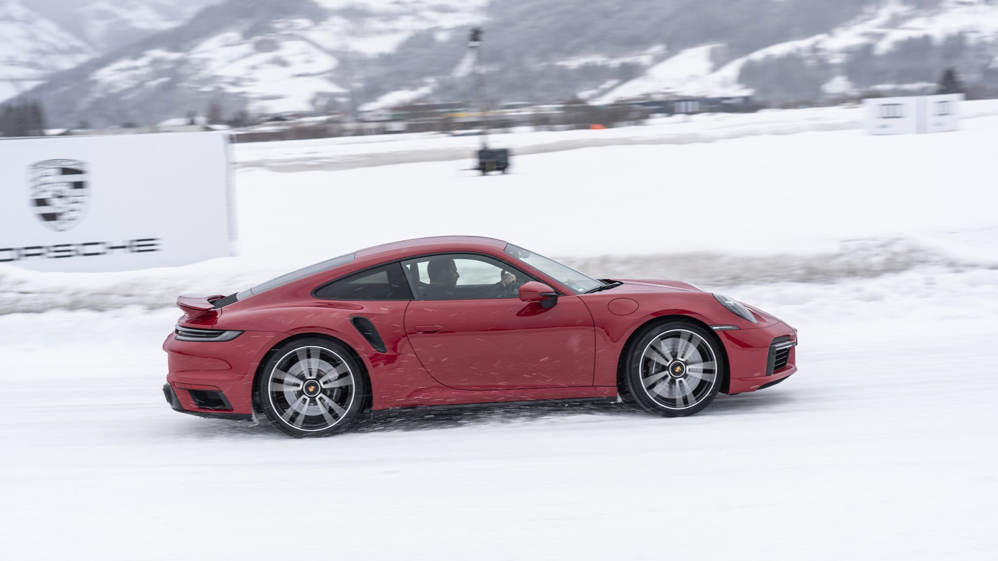 Side view of a red Porsche 911 Turbo S on the snow