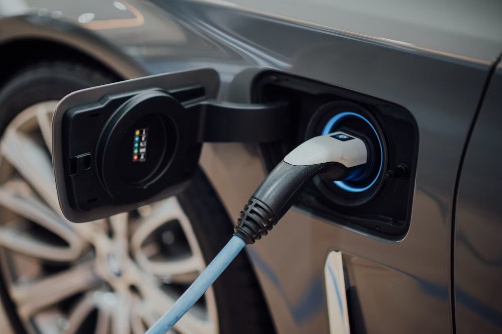 EV charging plug attached to car