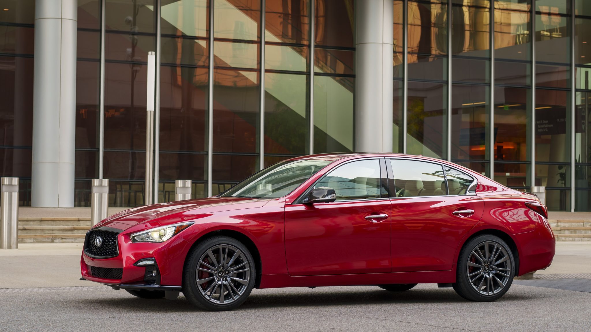 Side view of a 2024 red Infiniti Q50