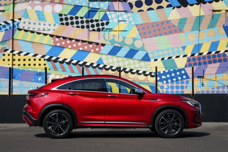 Side view of a 2024 red Infiniti QX55