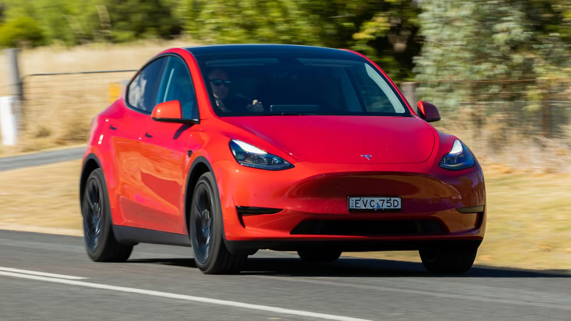 Front-angled view of a red Tesla Model Y