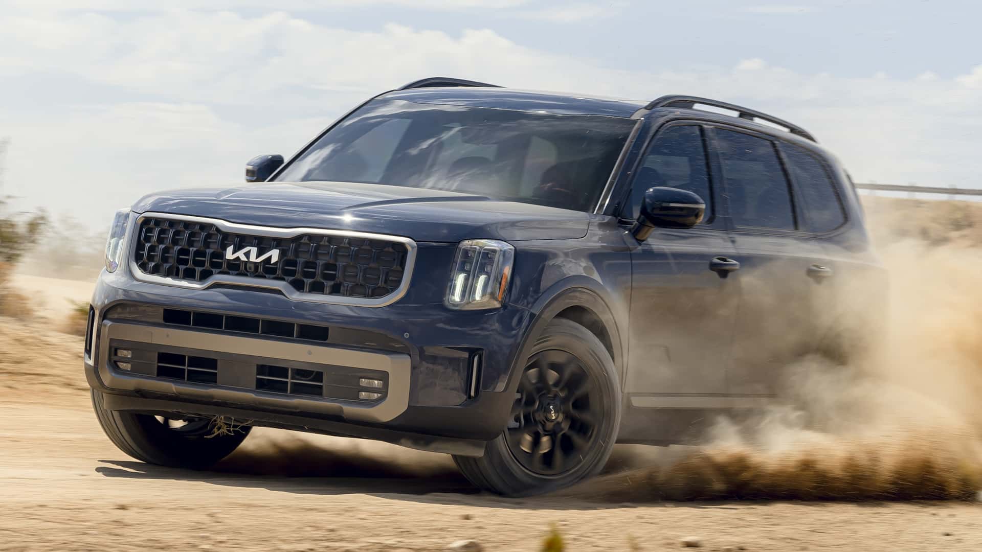 front-angled view of a dark blue 2024 Kia Telluride off-roading.