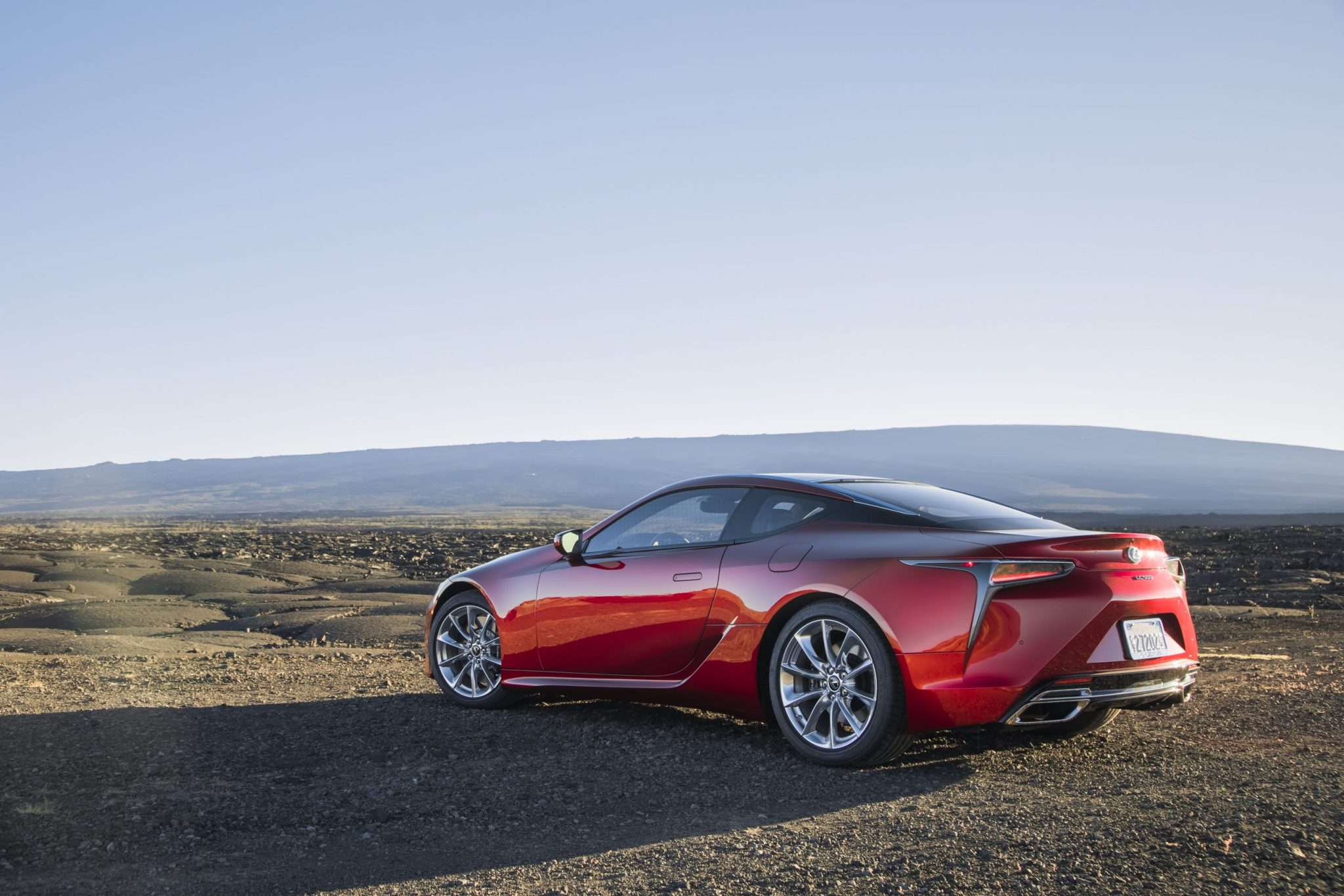 Three-quarter rear view of a 2024 red Lexus LC 500