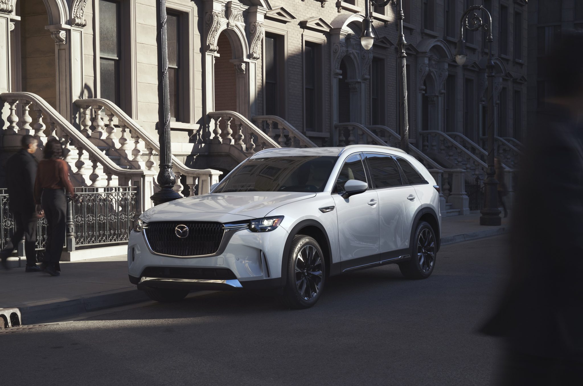 Three-quarter front view of a 2024 white Mazda CX-90 PHEV