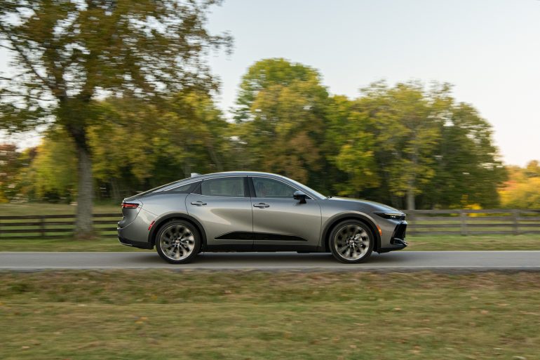 Side view of a 2024 silver Toyota Crown on a city street
